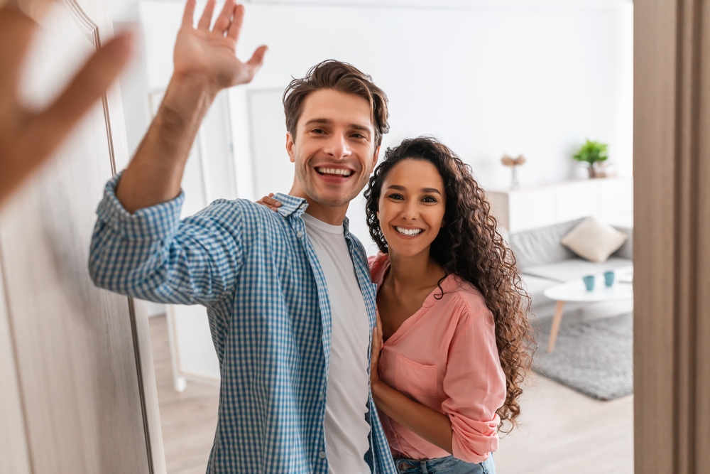 Smiling couple standing together at home