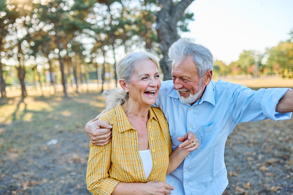 Older couple smiling together outdoors