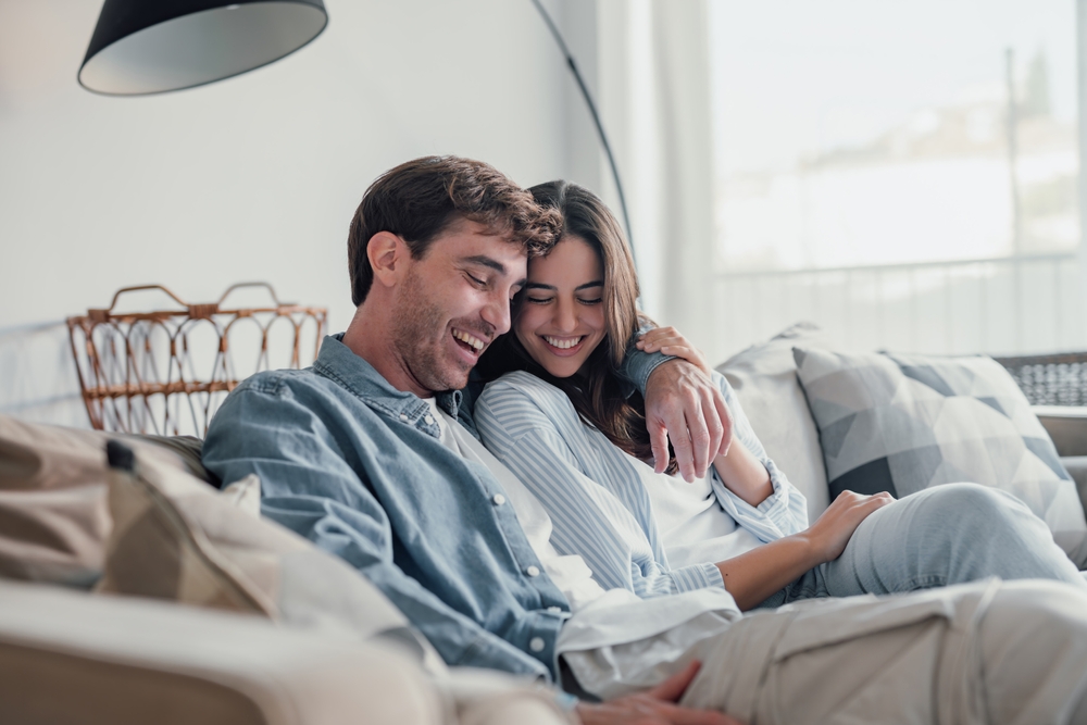 Smiling couple relaxing together on a sofa